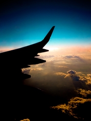 飞入云端的飞机尾翼摄影图片